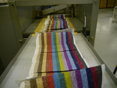 The yarn is glued to the paper and then cut into cards.