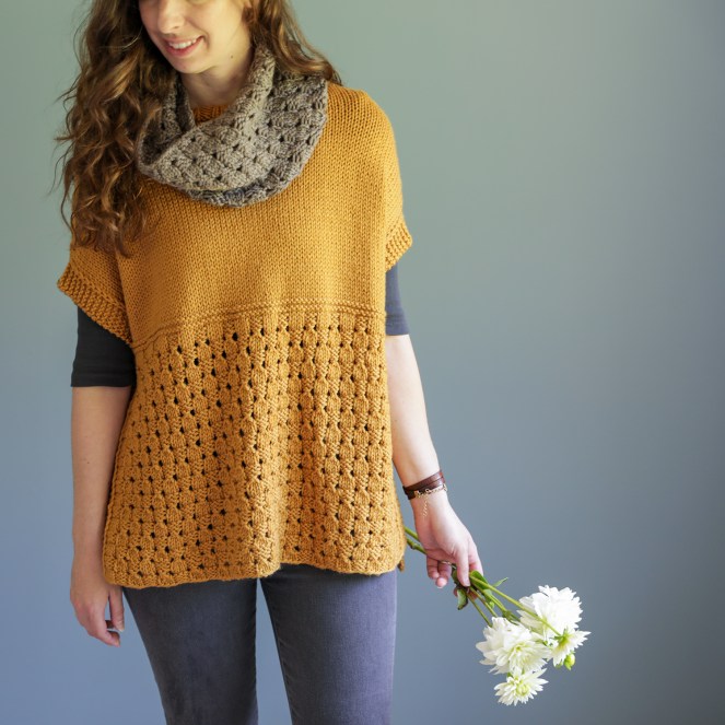 Photo of the Happy Harvest poncho and cowl set with model holding flowers in her hand