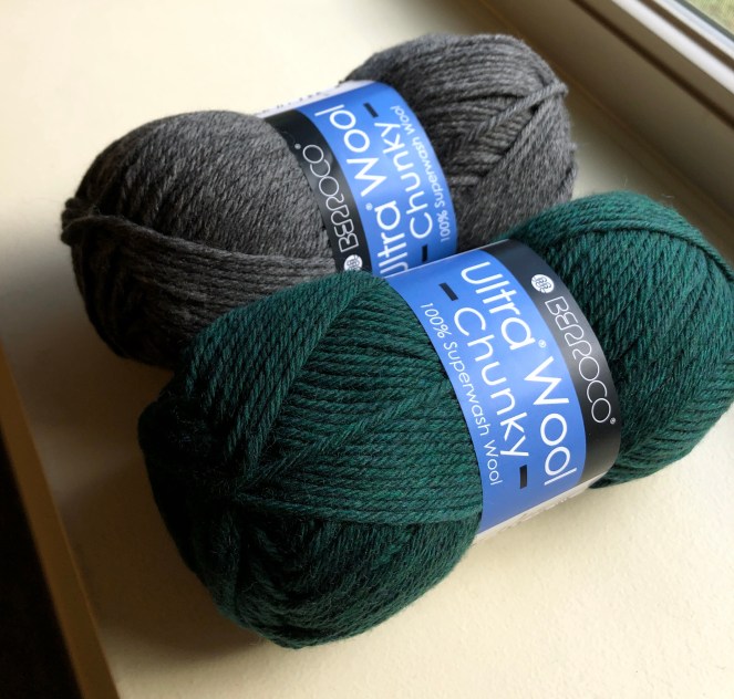photo of two balls of berroco ultra wool chunky, one in the pine color and one in charcoal